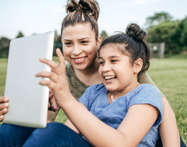Woman and girl looking at iPad